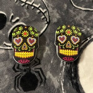 Two sugar skulls tin cans